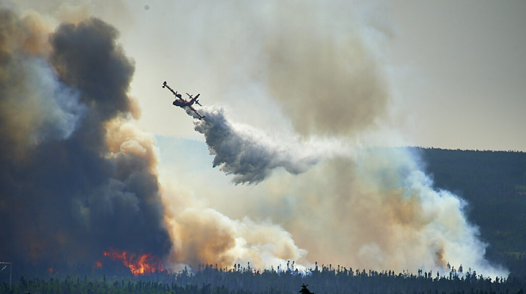 Wild fire in Newfoundland. A water bomber drops water on a wildfire near Paddy's Pond, just to the west of St John's, Newfoundland in August 2025. Photo by Greg Locke © 2025 Wild fire in Newfoundland. A water bomber drops water on a wildfire near Paddy's Pond, just to the west of St John's, Newfoundland in August 2025. Photo by Greg Locke © 2025